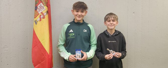 Schüler mit Preis vor Spanischflagge